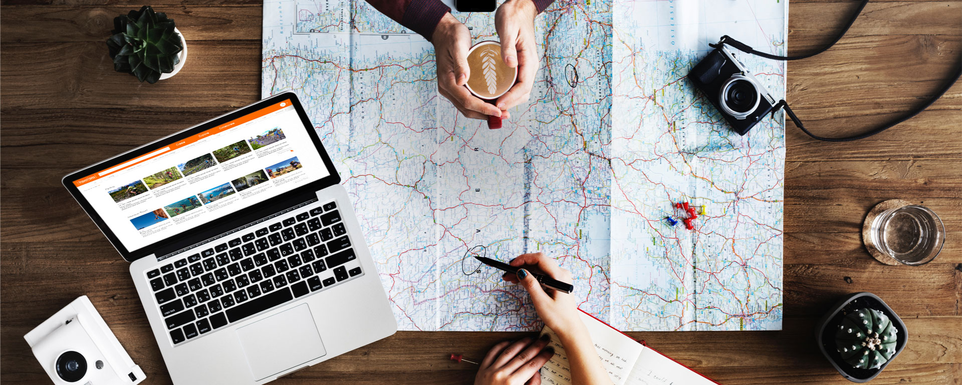 Travel planning with maps and laptop